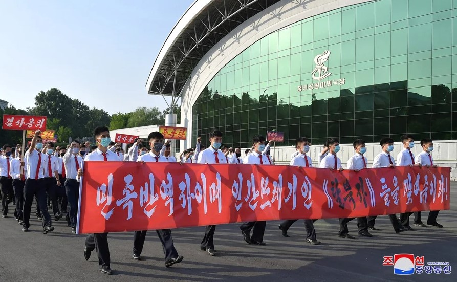 North Korean students holding anti-defector signs in Pyongyang